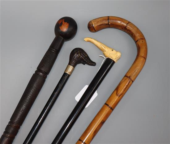 Four various walking canes, one with an ivory handle